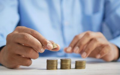 a person stacking coins on top of a table